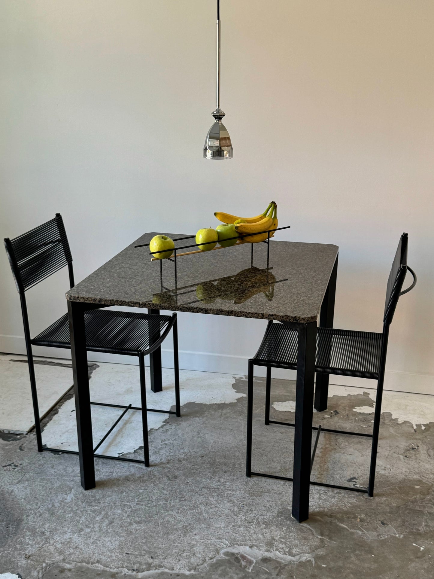 Square dining table with granite top by Alias